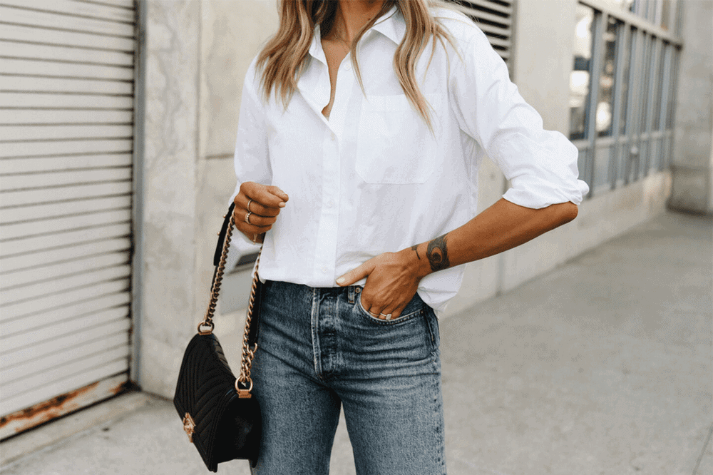 mujer con camisa blanca de manga larga y vaqueros