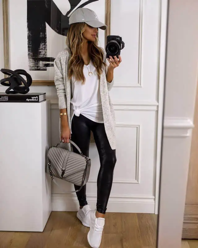mujer de estilo sporty con leggins negros y sneakers blancas